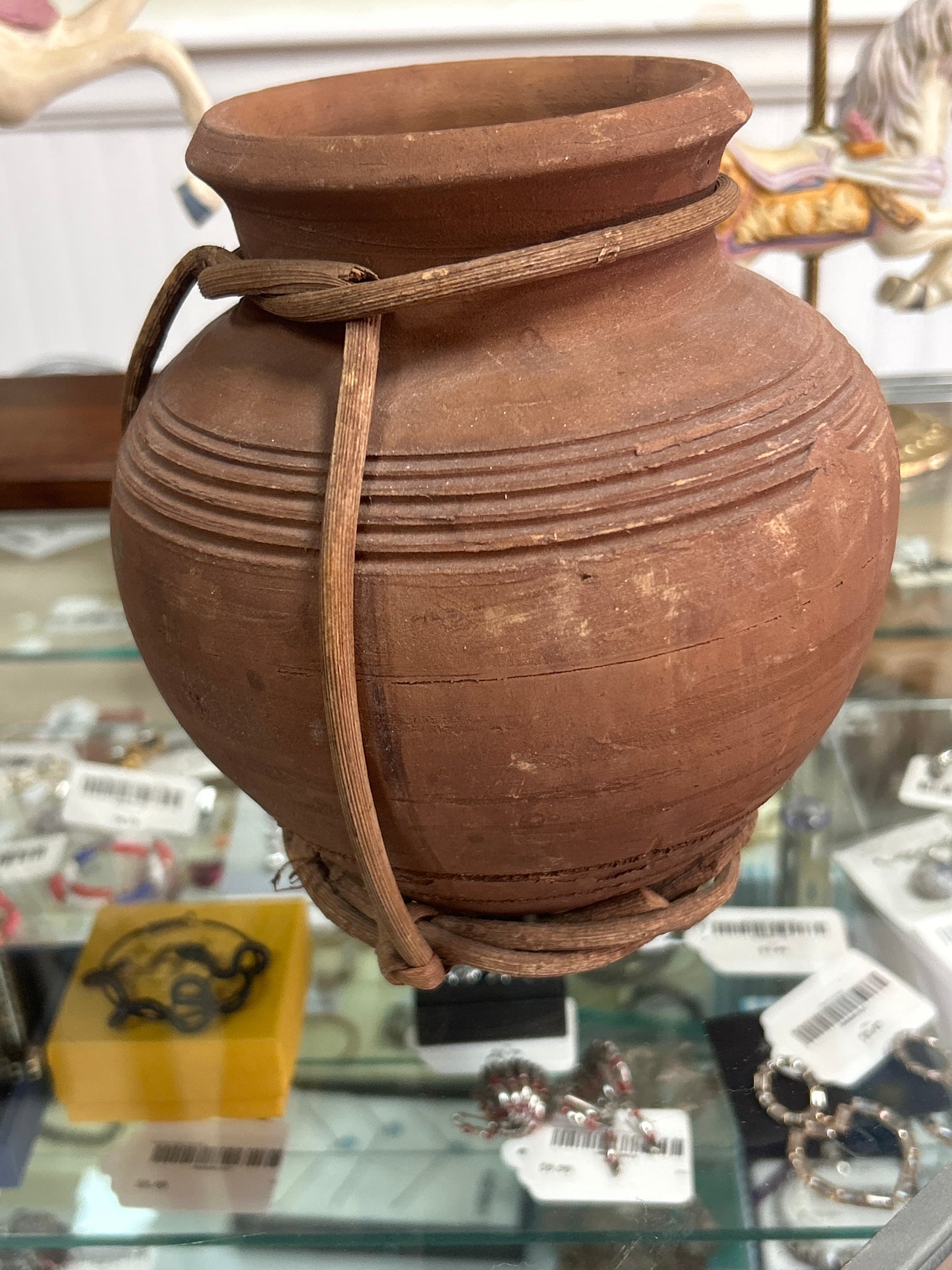 Vase with vines around base and neck