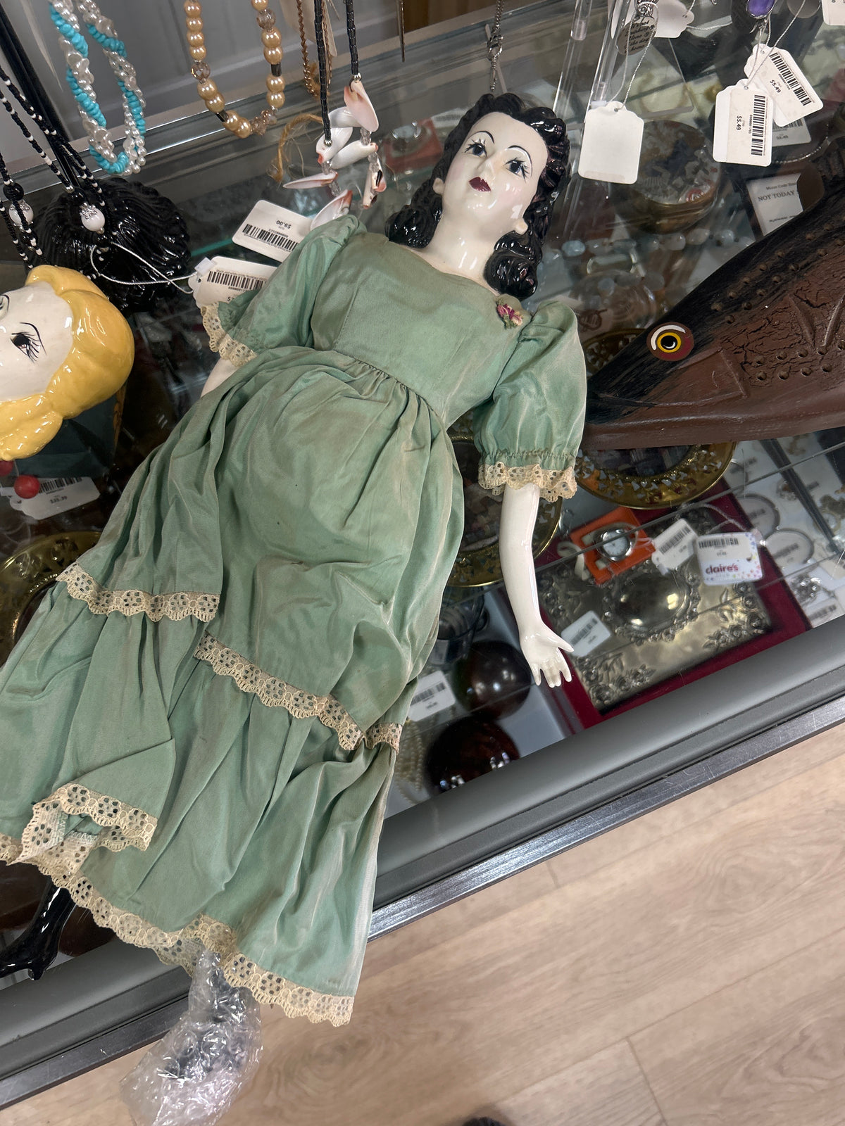 Antique-style doll features a glazed china head with painted features and molded black hair, resembling popular 19th-century German designs