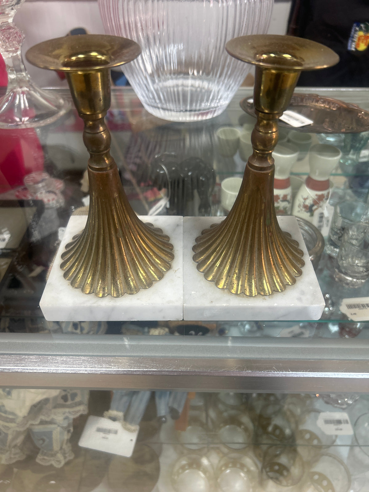 Vintage mid-century modern brass candlesticks with ribbed fluting on white carrera marble bases