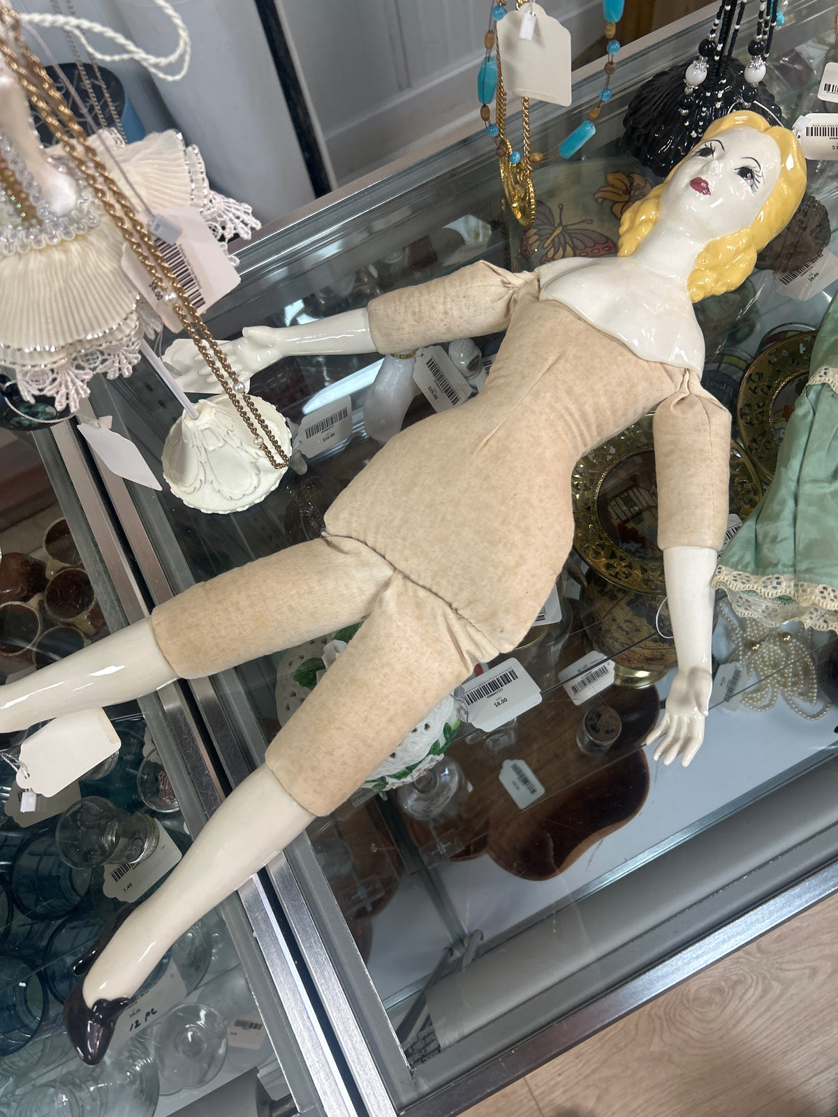 antique-style doll features a glazed china head with painted features and molded blonde hair, resembling popular 19th-century German designs
