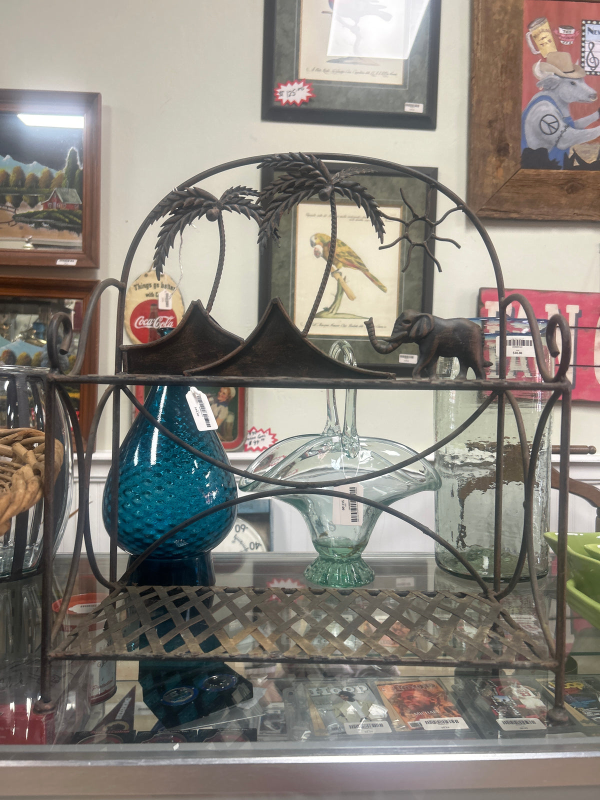 Wrought iron tiered display stand tropical theme with palm trees and a sun motif