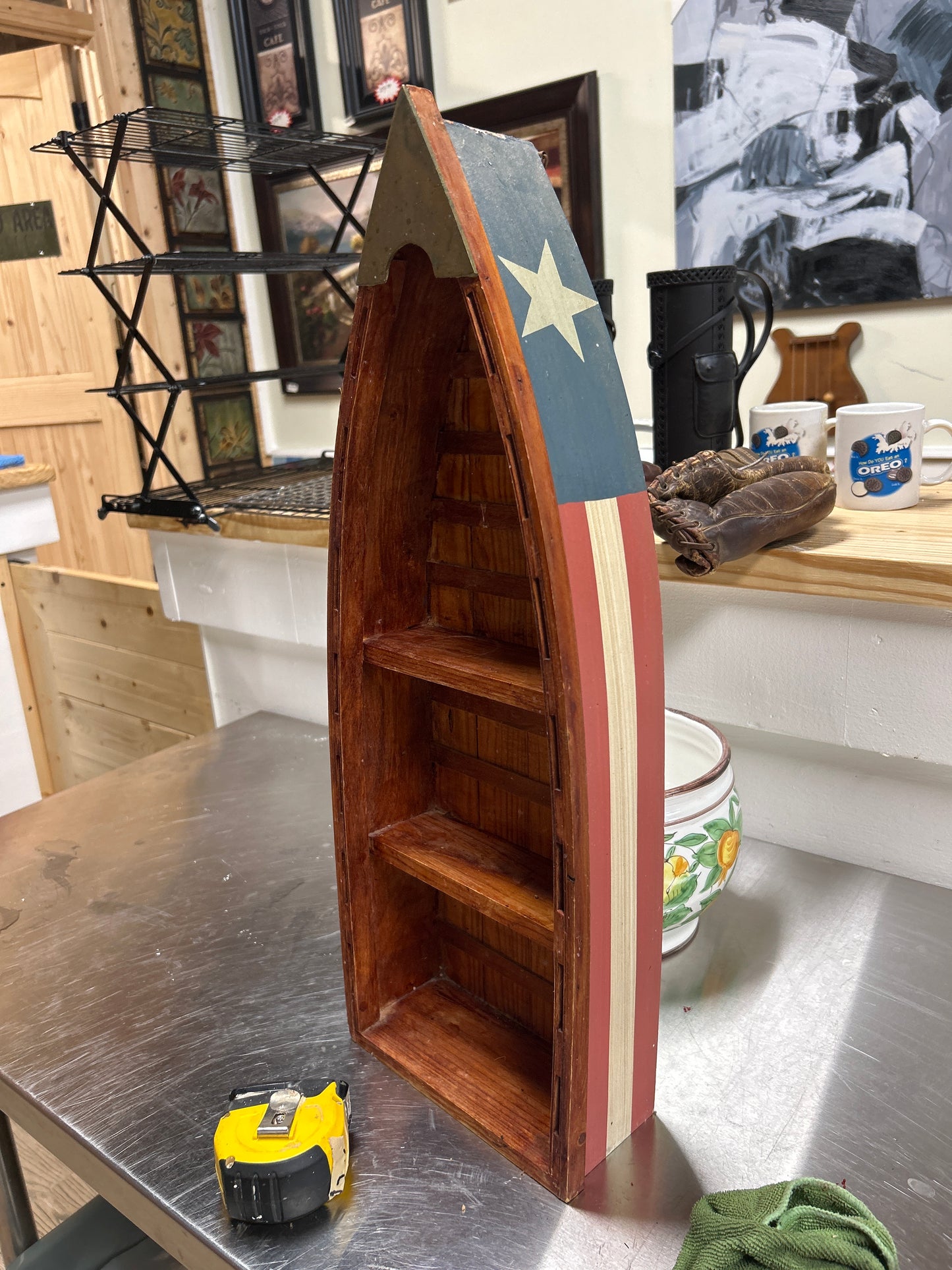 Boat-shaped shelf with a patriotic stars and stripes design 22”