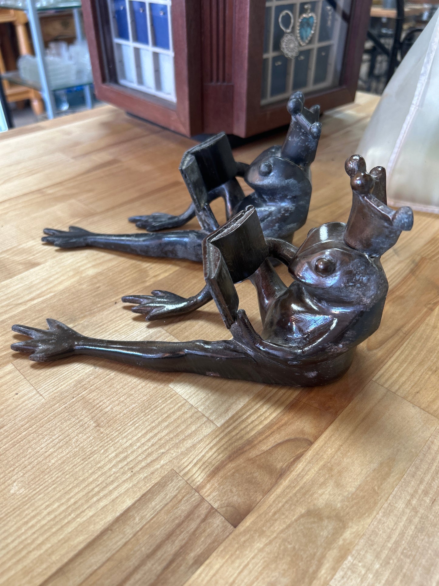 Set of Restoration Hardware Frog Prince Cast Bronze Bookends 8.25", Long Frog Legs King Crown Reading a Book, Heavy Metal. One seems gray and the other bronze color