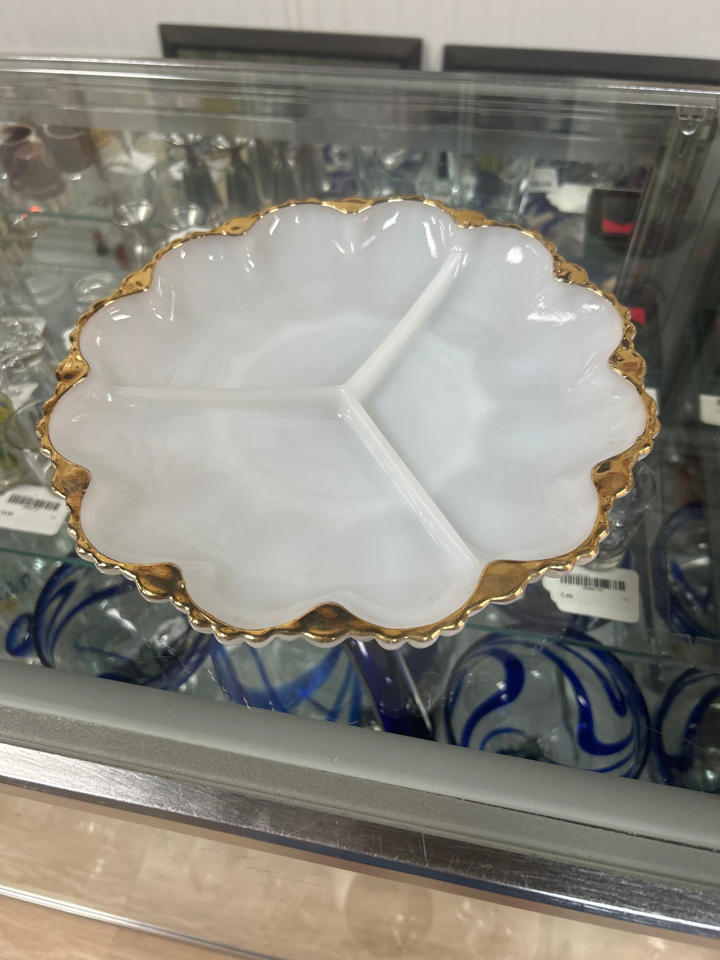 Vintage Anchor Hocking Fire-King milk glass divided relish tray or serving dish, often featuring gold trim around the scalloped rim.