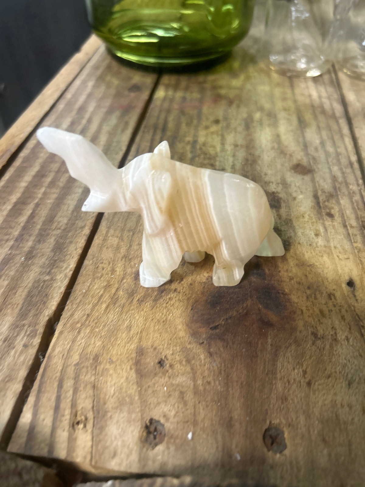 Hand-carved white onyx marble elephant with its trunk up