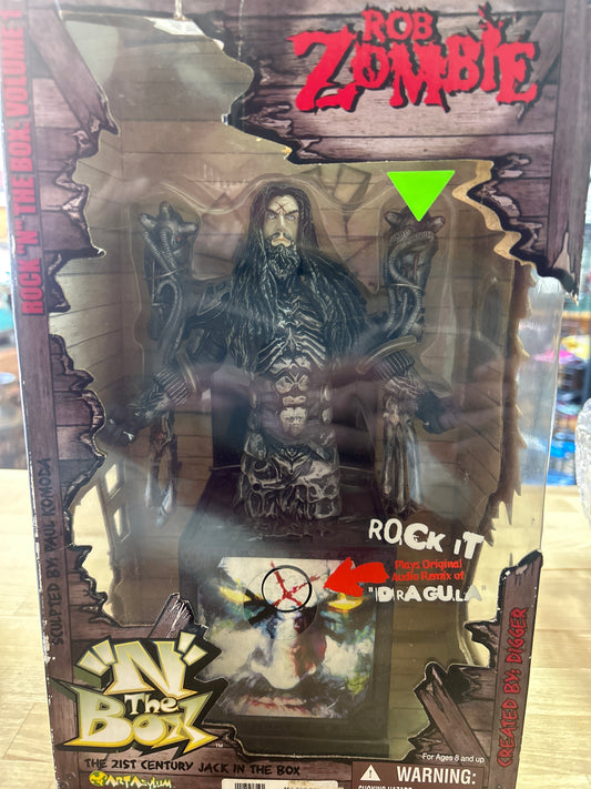 Rock ‘N The Box: Rob Zombie Figure. Box is a little dirty and has a few small tears and creases but it is unopened and sealed with original tape. Working! NIB