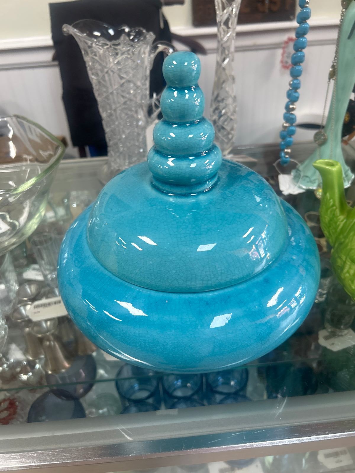 Turquoise lidded jar features a distinctive beehive-style stacked finial design and a glossy finish.
