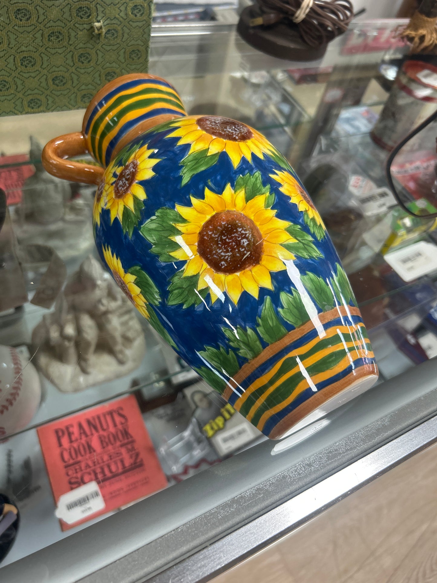 Wall-hanging bottle decorated with blue and yellow accents, produced exclusively by Burton & Burton