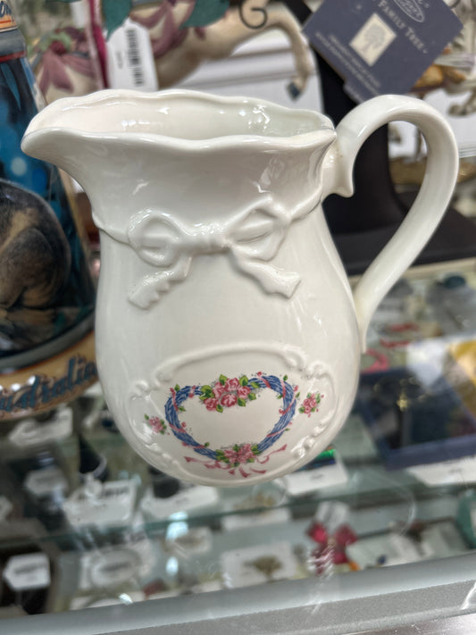 Vintage pitcher with a floral heart and bow pattern 6”