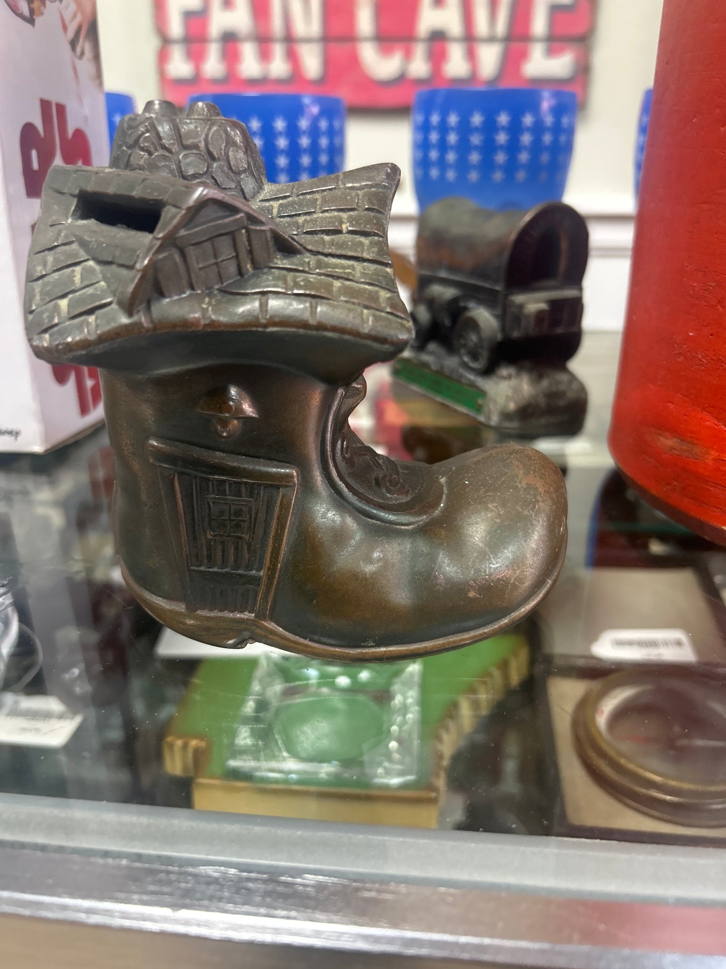 vintage figural coin bank is styled as the "Little Old Woman Who Lived in a Shoe"
