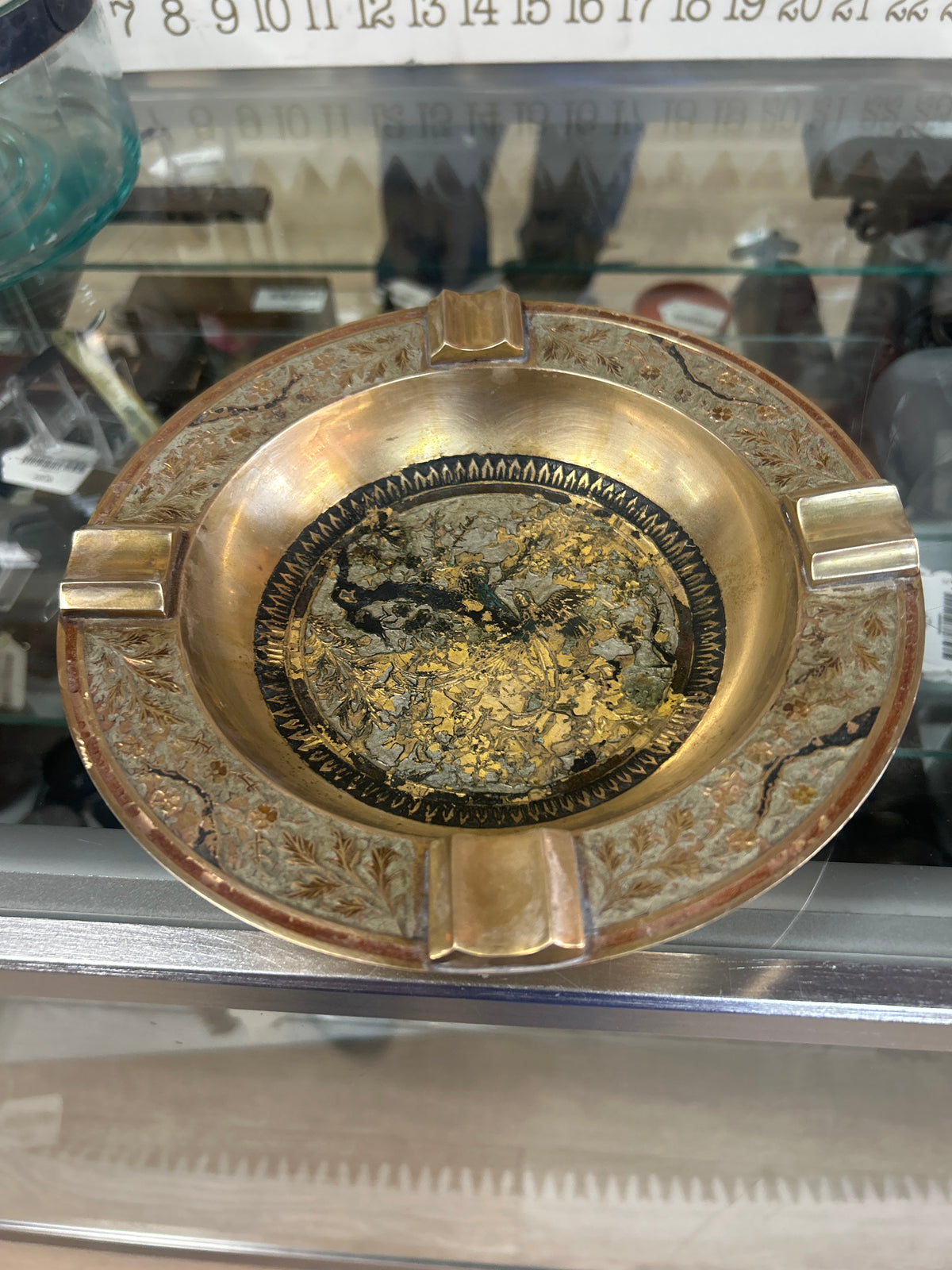 An ornate vintage brass cigar/cigarette ashtray